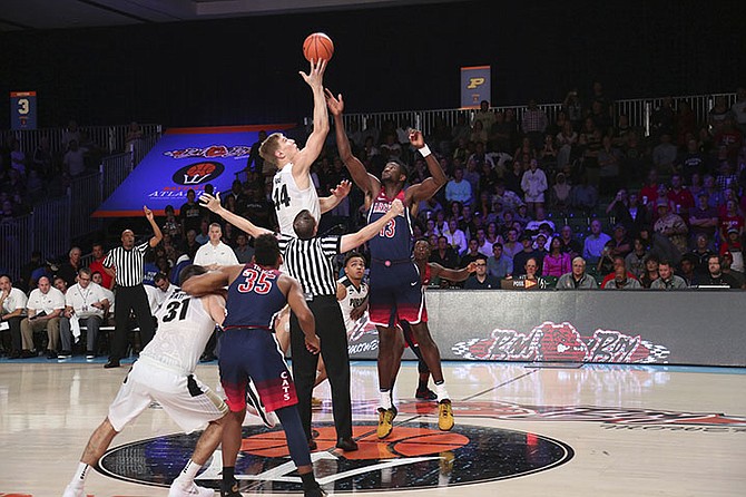 In this photo provided by Bahamas Visual Services, Purdue center Isaac Haas (44) wins the tip-off over Arizona forward Deandre Ayton (13) during an NCAA college basketball game Friday, Nov. 24, 2017, in the Battle 4 Atlantis tournament in Paradise Island,
