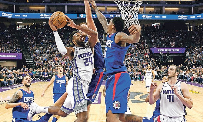 Sacramento Kings guard Buddy Hield, left, goes to the basket against Los Angeles Clippers’ Blake Griffin, rear, and Lou Williams, front right, in the second half of Saturday’s game in Sacramento, California. The Clippers won 97-95.

(AP Photo/Rich Pedroncelli)

 