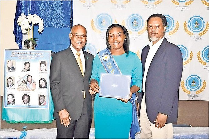 National Teacher of The Year 2017-2019 Antonique Josey accepts a certificate of appreciation. From left, Minister of Education Jeffrey Lloyd, Mrs Josey, and acting director of education Marcellus Taylor. Photo: Edgar Arnette 

 