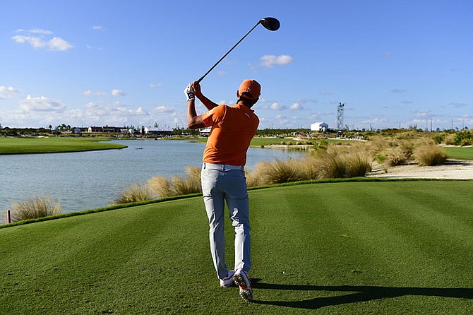 Rickie Fowler watches his shot from the 18th tee during the final round of the Hero World Challenge golf tournament at Albany Golf Club in Nassau, Bahamas, Sunday. Fowler won the tournament. (AP Photo/Dante Carrer)

