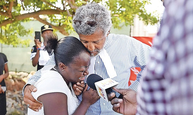 Attorney Fred Smith with Clotilde Jean-Charles, sister of Jeanrony Jean-Charles, who is said to be missing from the Detention Centre. Photo: Shawn Hanna/Tribune Staff