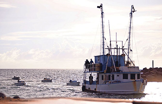 A RBDF file photo shows one of the apprehended vessels with skiffs in tow entering the RBDF Coral Harbour Base. Photo: RBDF Public Relations Section

