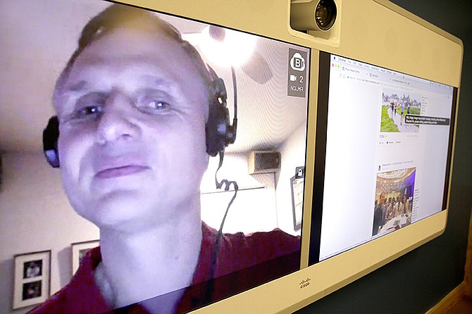 Engineer Matt King, who is blind, demonstrates facial recognition technology via a teleconference at Facebook headquarters in Menlo Park, Calif. Facebook is unveiling a new AI-powered feature just in time for alcohol-filled holiday parties: you can now see untagged pictures of your face on your friend’s news feeds and ask the poster to remove them. (AP Photo/Eric Risberg)