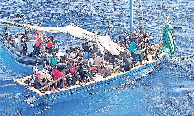 THE RBDF boarding team apprehending 87 Haitian migrants off Great Inagua on Saturday, December 23. Photo: USCG

 