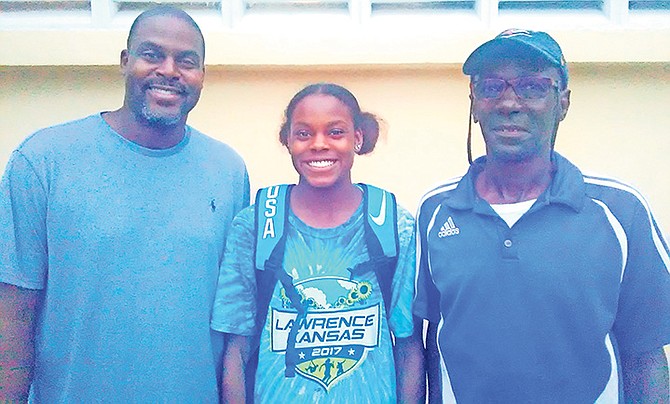 Coach Peter Pratt (right) poses with triple jumper Jasmine Moore and her father Earl Moore.