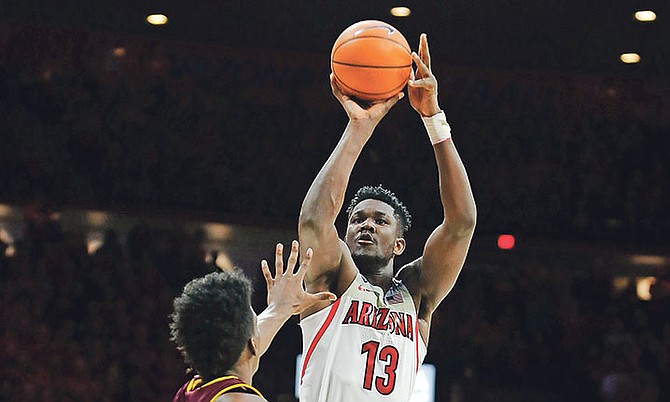 Arizona forward DeAndre Ayton, of the Bahamas, shoots the ball over the defence of Arizona State’s De’Quon Lake during the second half of Saturday’s game in Tucson, Arizona.

(AP Photo/Ralph Freso)

 