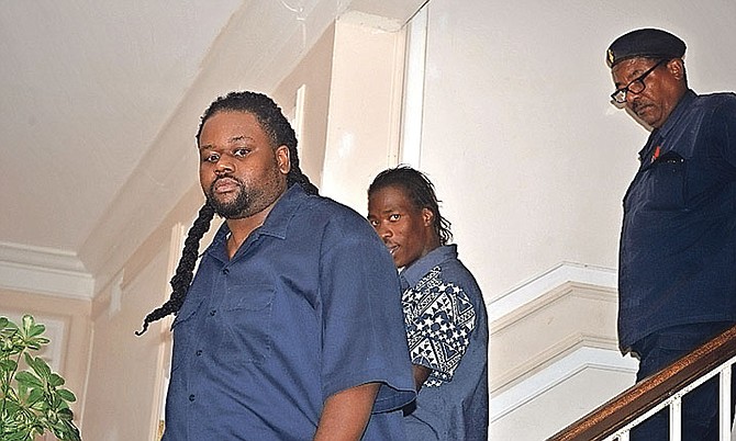 Clive G Wyatt, in front, and Delano Black, behind him, appeared in the Supreme Court in Grand Bahama for a bail hearing. 

 