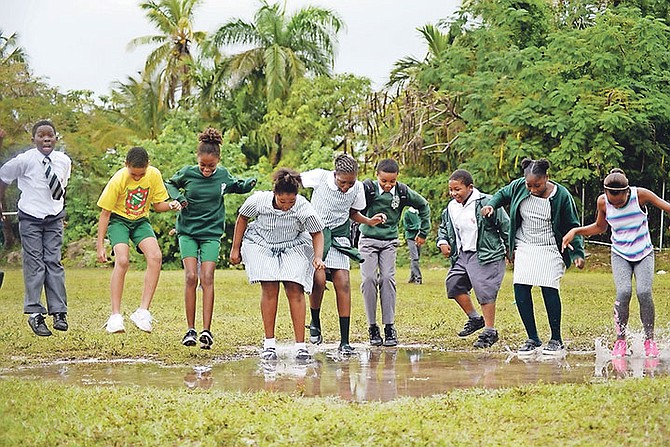 Youngsters are pictured out having fun in the rain yesterday. Photo: Shawn Hanna/Tribune Staff

