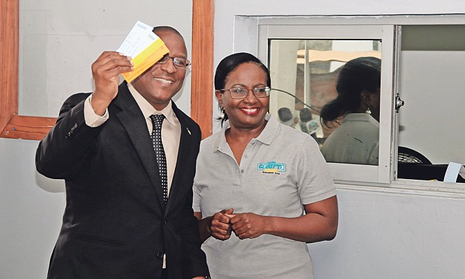 Minister Michael Pintard and BAAA president Rosamunde Carey are pictured above after he purchased his tickets for Carifta.