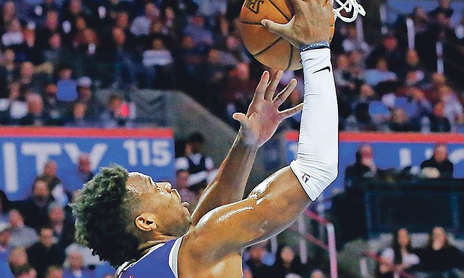 Sacramento Kings guard Buddy Hield (24) shoots in front of Oklahoma City Thunder forward Paul George, right, in the second quarter of last night’s game in Oklahoma City.
