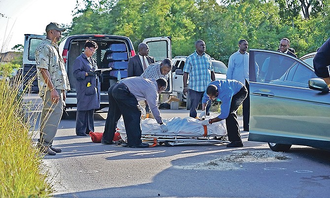 OFFICIALS at the scene of a police-involved shooting that left two men dead. Photo: Terrel W. Carey/Tribune Staff