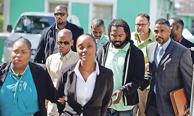Five people appeared before the Magistrate Court yesterday on charges related to a $280,000 fraud. Pictured are (front) Shukuanya Thompson; (middle left) Randolph Smith and (middle right) Kareem Murphy; (back left) Jeramie Stuart and (back right) Anderson Johnson. Photo: Shawn Hanna/Tribune Staff
