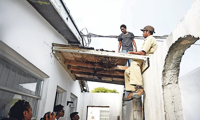 Contractor Allan J Bain and his assistant starting work to replace the entire roof, which could take about 4 weeks to complete.

 