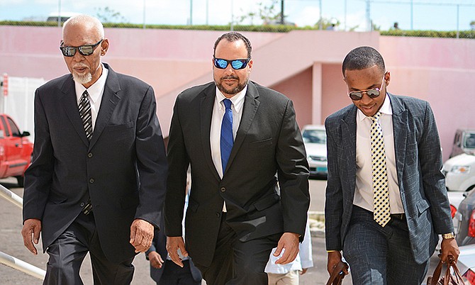 Former Senator Frank Smith (centre) arriving at Magistrate’s Court on Monday. Photo: Shawn Hanna/Tribune staff