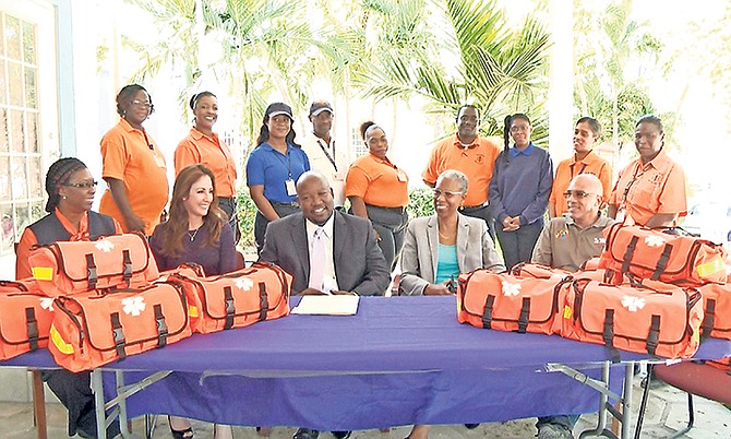 Seated from left, front row: Dr Alvery Hanna, NEMS director; Michele Moodie, VP Ports International; Julian Rolle, chairman PHA; Catherine Weech, PHA managing director, Ollie Dupuch Ferguson, COO Tribune. Standing back row: NEMS Staff.


