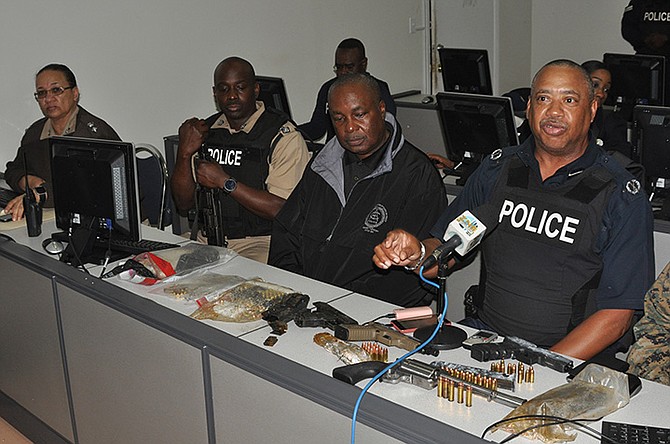 ACP Clayton Fernander and ACP Samuel Butler, officer in charge of Grand Bahama district, along with a team of law enforcement officers, speak with the press following the joint operation that resulted in seizure of drugs, cash, and, firearms and ammunition in Grand Bahama. Seen are the firearms and ammunition that were recovered. Photo: Vandyke Hepburn
