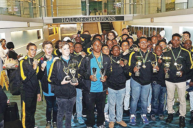 WATER POLO CHAMPIONS: The Bahamas’ water polo programme won gold medals in all three age categories - under-14, under-16 and under-19 - at the CARIFTA Games in Kingston, Jamaica. The three teams returned home on Monday night and can be seen above at the Lynden Pindling International Airport in New Providence. Team Bahamas was congratulated by Minister of Youth, Sports and Culture Michael Pintard.  
                                                                                                                                                                                                           Photo: Raymond A Bethel Sr/BIS