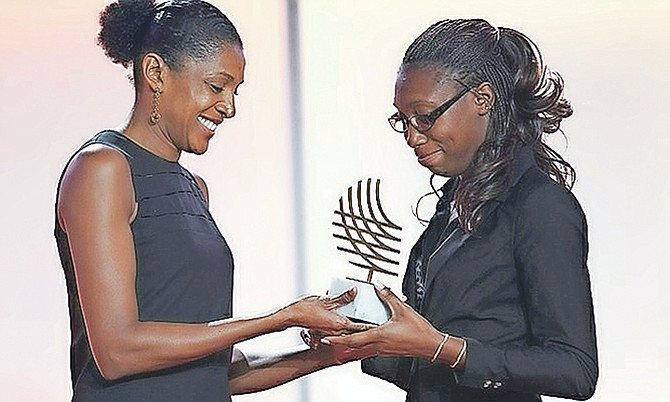 ANTHONIQUE Strachan receives her IAAF Rising Star award from Marie Jose Perec (left).