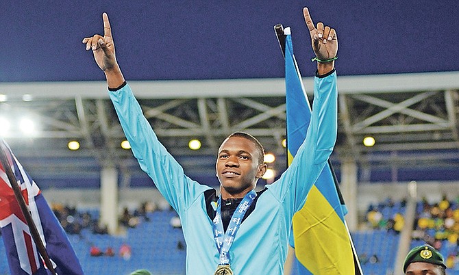 Joel Johnson on the podium with his 100m gold medal from the Carifta Games. Photo: Shawn Hanna/Tribune staff