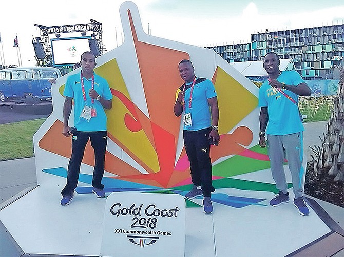 BOXERS Rashield Williams and Carl Hield (far right), along with coach Valentino Knowles (centre) in the Games Village.