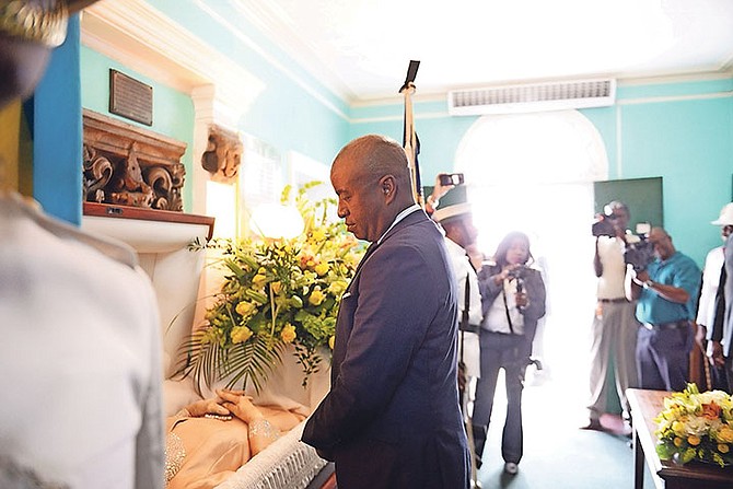 North Abaco MP Darren Henfield pays his respects to Theresa-Moxey Ingraham. 
Photo: Shawn Hanna/Tribune Staff