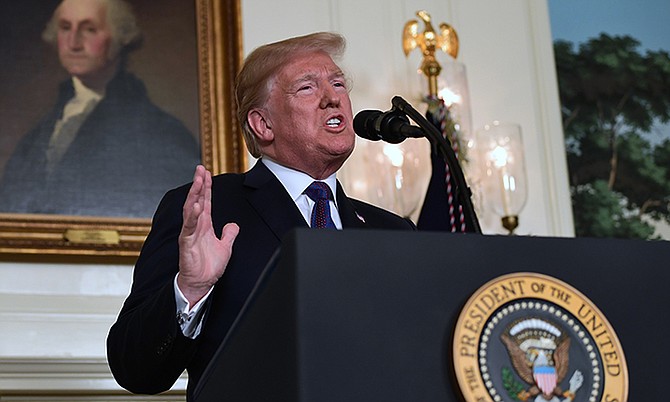 President Donald Trump speaks in the Diplomatic Reception Room of the White House on Friday in Washington. (AP Photo/Susan Walsh)

