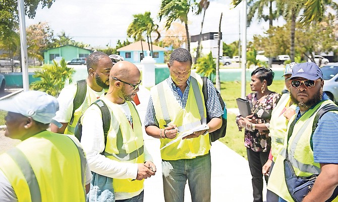 Officials are pictured preparing to begin the shanty town census. Photo: Shawn Hanna/Tribune Staff
