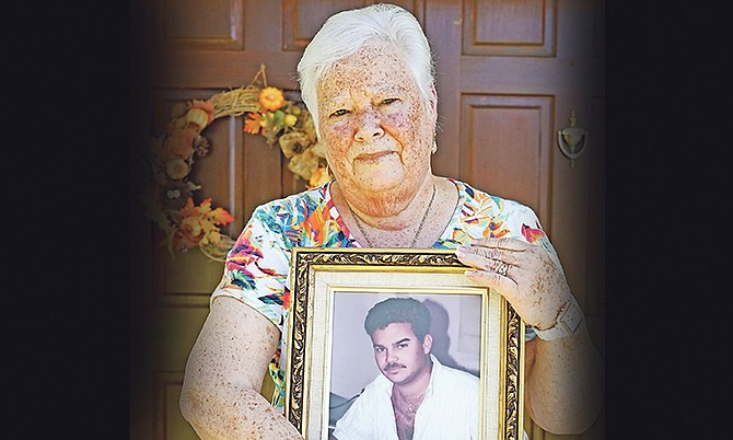 Emma Cartwright holds a photograph of her son, Andre Cartwright, who was murdered at the family’s home in Blair Estates. Photo: Terrel W. Carey/Tribune Staff