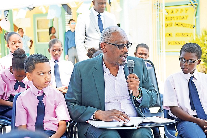 Prime Minister Dr Hubert Minnis reading a storybook to students at his belated birthday celebration yesterday at Gambier Primary School. Photo: Shawn Hanna/Tribune Staff