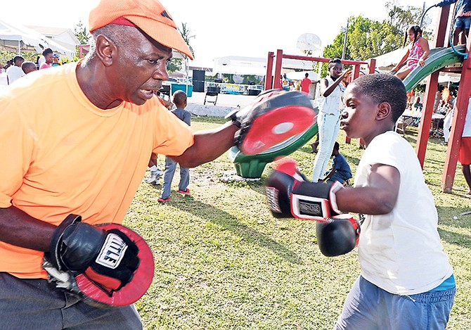 A young boy taking boxing lessons at the Ministry of Youth, Sports and Culture’s “Youth and Culture in the Park” event in Free Town on April 21. Photo: Eric Rose/BIS