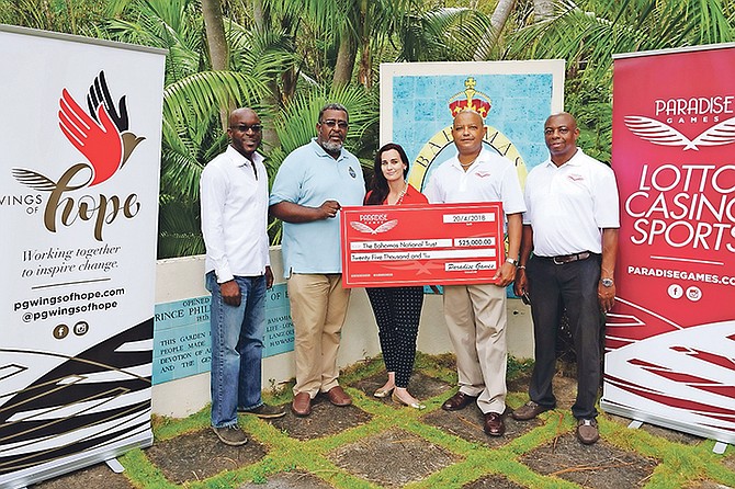 A cheque is presented to the Bahamas National Trust from Paradise Games.