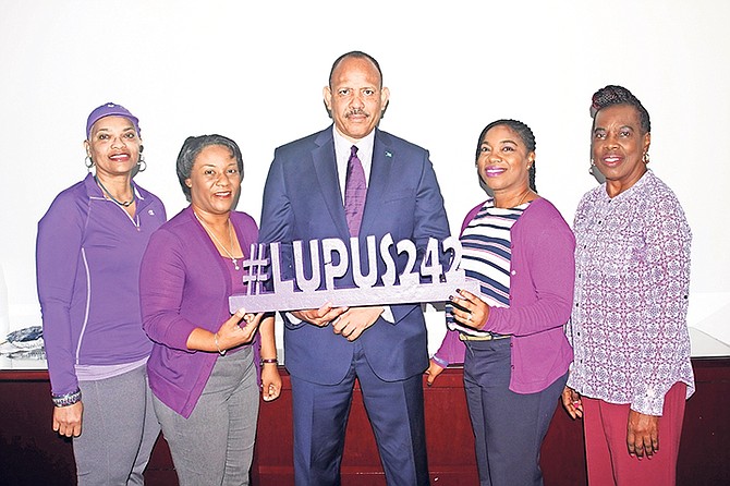 Wearing purple, (l-r) Shirl Gaskins, Lupus 242 member; Shandesia McFall; secretary for Lupus 242; Shonalee King-Johnson, vice president and PR officer for Lupus 242, and Sarahlee Williams, Lupus 242 member, paid a courtesy call on Health Minister Dr Duane Sands (centre), who wore a purple tie for the occasion.

 

 
