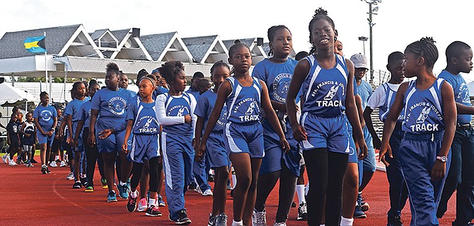 Defending champions St Francis & Joseph lead the march past before they won their sixth straight Catholic Primary School Track and Field Championships.