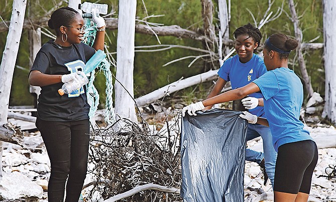 Youth volunteers help clean Barbary beach, in Freeport, Grand Bahama.

