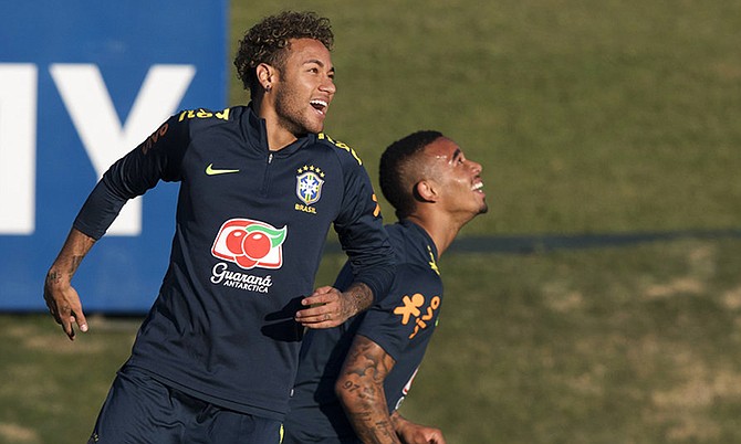 Brazil's Neymar, left, prepares to jump next to Gabriel Jesus during a practice session of the Brazil national soccer team at the Granja Comary training centre, in Teresopolis, Brazil, Tuesday. (AP Photo/Leo Correa)

