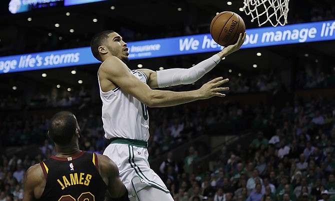 Boston Celtics forward Jayson Tatum goes to the basket over Cleveland Cavaliers forward LeBron James during the fourth quarter of Game 5 of the Eastern Conference finals last night.

(AP Photo/Charles Krupa)

 