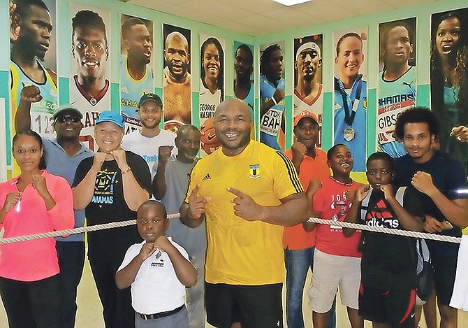 BAHAMIAN pro boxer Sherman ‘The Tank’ Williams (centre) at his first public training workout session at the YMCA with executive director Karen Johnson and some of the youngsters.

Photo: Denise Maycock/Tribune staff