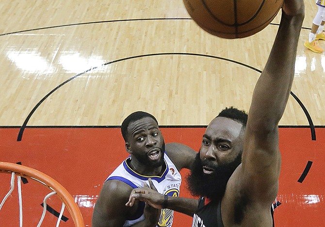 Houston Rockets guard James Harden scores over Golden State Warriors forward Draymond Green in the first half of Game 5 of the NBA Western Conference Finals in Houston last night. The Rockets won 98-94.

(AP Photo/David J Phillip)

 