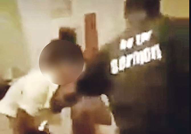 A still from one of the videos showing the girl being beaten.