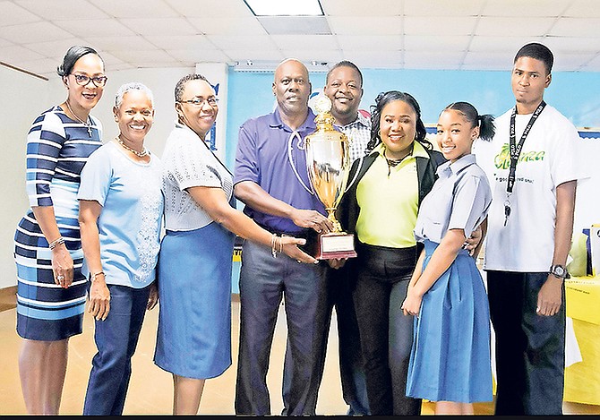 (l-r) Beverley Hamilton and Arlene Major, senior mistresses of St Anne’s; Cynthia Wells, principal of St Anne’s; Joel Cunningham, sales manager at Milo Butler; Damian Butler, managing director of the Milo Butler Group of Companies; Shema Poitier, brand manager, Milo Butler; Raven McPhee, student, and Christopher Thompson, sales merchandiser, Milo Butler. (Photo/Derek Smith Jr) 

 