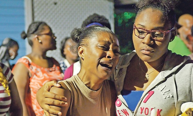 TEARS during last night’s candlelight vigil on Father Marshall Cooper Park for De’Angelo “Dee” Evans, who was shot and killed by police on Sunday. Photo: Shawn Hanna/Tribune staff