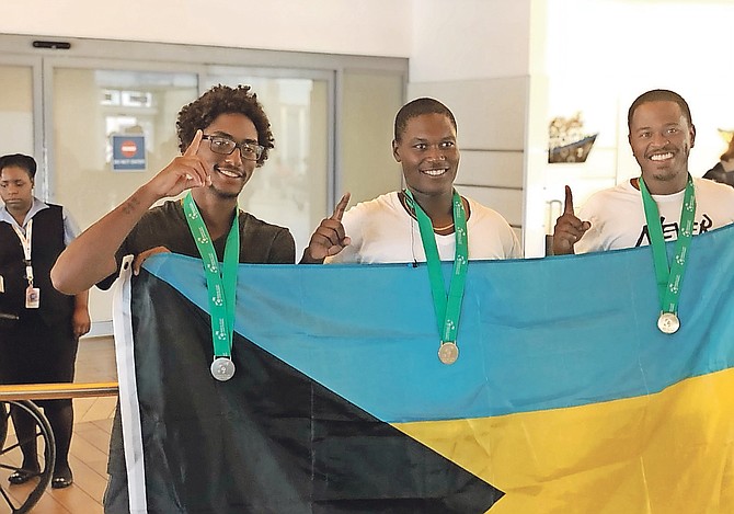 FROM LEFT: Jody Turnquest, Philip Major Jr and Marvin Rolle with their medals. Photo: Fina Johnson