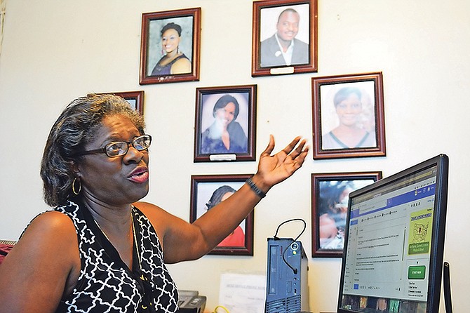 Bahamas Financial Services Union President Theresa Mortimer pointing to a photograph of Tami Gibson on her wall. Photo: Shawn Hanna/Tribune staff