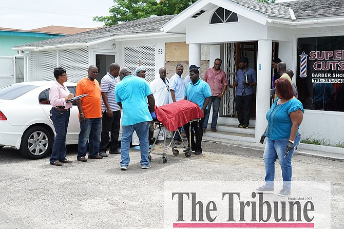 The body of one of the victims is removed from the scene on Saturday morning. Photo: Terrel W Carey/Tribune staff