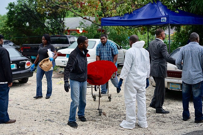 The body is removed from the scene on Cox Street. Photo: Terrel W Carey/Tribune staff