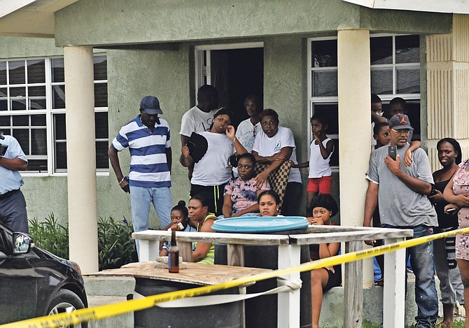 Distraught onlookers at the scene in Grand Bahama. Photo: Vandyke Hepburn