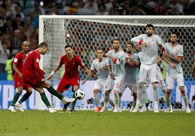 Portugal's Cristiano Ronaldo, left, scores his side's equalising goal. (AP)