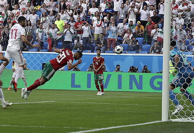 Morocco's Aziz Bouhaddouz, 20, scores an own goal during the group B match between Morocco and Iran. (AP)
