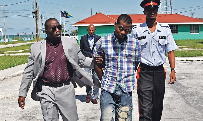 Jaycee Simmons being led to court in Eight Mile Rock to face a charge of attempted murder. Photo: Vandyke Hepburn
