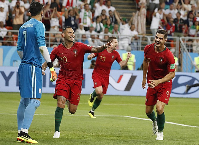 Portugal's Ricardo Quaresma, second left, celebrates scoring his team's opening goal along with teammate Portugal's Andre Silva during the group B match between Iran and Portugal at the 2018 soccer World Cup at the Mordovia Arena in Saransk, Russia. (AP Photo/Pavel Golovkin)